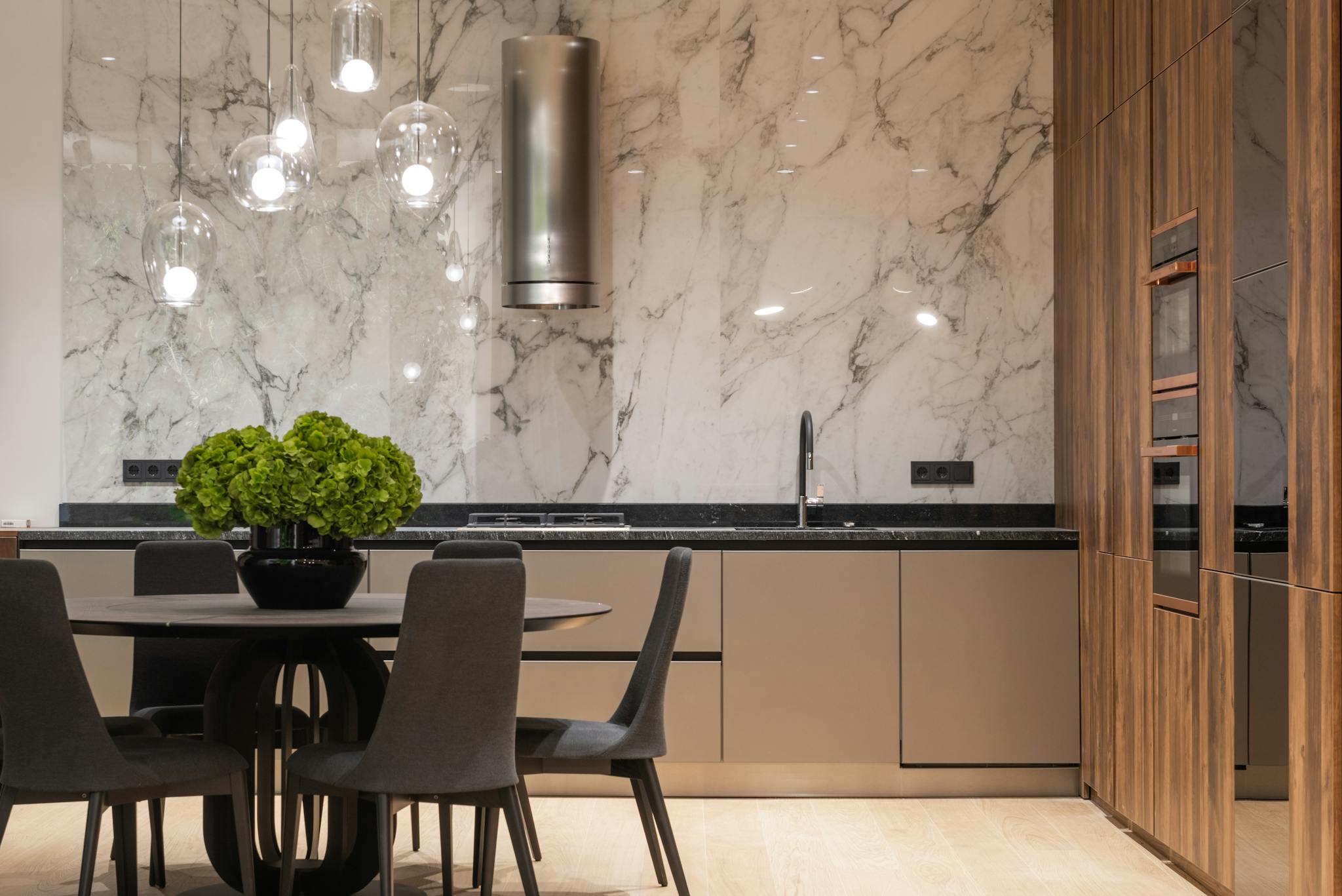 Interior of stylish kitchen with minimalist furniture and round table with chairs